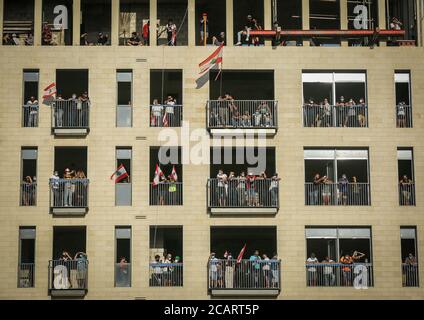 Beirut, Lebanon. 08th Aug, 2020. People wave Lebanese flags from balconies during a massive demonstration against the Lebanese government, in the aftermath of Tuesday's port explosion that rocked the capital. Credit: Marwan Naamani/dpa/Alamy Live News Stock Photo