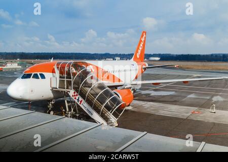 Milan Italy - January 30, 2019: Easy Jet company airplane and boarding stairs, preparations before flight in Malpensa Airport (Milan, Italy) on januar Stock Photo