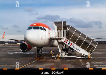 Milan Italy - January 30, 2019: Easy Jet company airplane and boarding stairs, preparations before flight in Malpensa Airport (Milan, Italy) on januar Stock Photo