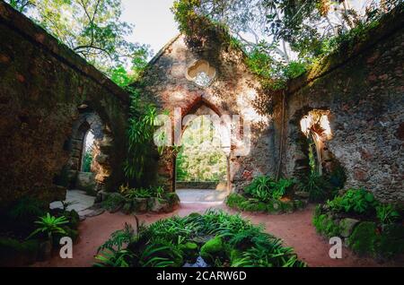 Sintra, Portugal - February 5, 2019: Ancient ruined roofless chapel in the botanical park of Monserrate, famous palace in Sintra, Portugal, on februar Stock Photo