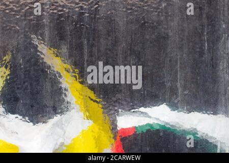 Structured glass texture background with red, white and yellow colors shining through it Stock Photo