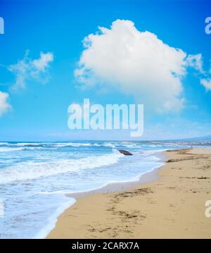 golden shore under a cloudy sky in Sardinia, Italy Stock Photo