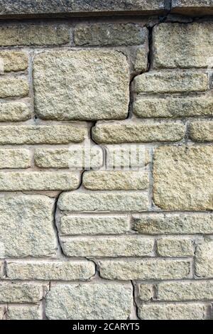 vertical crack in an old stone wall Stock Photo