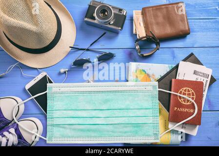 Coronavirus and safety travel concept. Travel business or vacation accessories and protective face medical mask, covid19 spread prevention measures, f Stock Photo