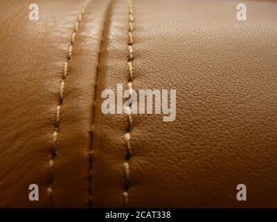 Closeup of an expensive leather sofa stitched with brown thread Stock Photo