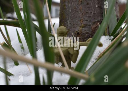 A Toy Soldier Taking Aim and Ready to Fight in Knee-Deep Snow Stock Photo