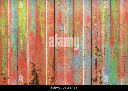 Rusty colorful rolling shutter. Rusty and coating color decay, steel rolling shutter. Ideal for urban and creative background. Stock Photo