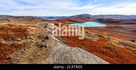 Autumn greenlandic orange tundra landscape with lakes and mountains in the background, Kangerlussuaq, Greenland Stock Photo
