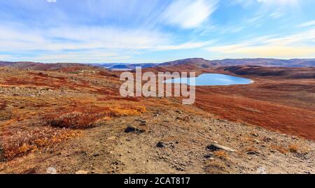 Autumn greenlandic orange tundra landscape with lakes and mountains in the background, Kangerlussuaq, Greenland Stock Photo