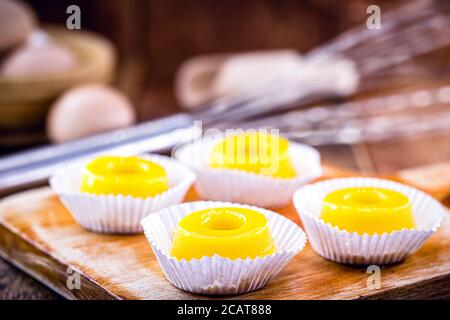 several sweets called 'Quindim', Brazilian sweet made from egg yolk, sugar and grated coconut. Yellow sweet typical of Brazilian cuisine. Stock Photo