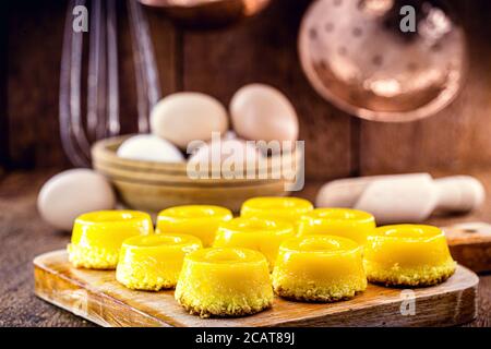 several sweets called 'Quindim', Brazilian sweet made from egg yolk, sugar and grated coconut. Yellow sweet typical of Brazilian cuisine. Stock Photo