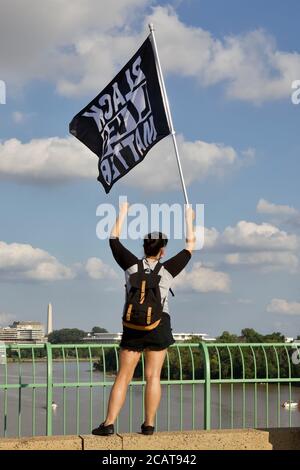 Washington, DC, USA. 8th Aug, 2020. Pictured: A protester flies a Black Lives Matter sign during a stop on the Key Bridge at the Black Lives Matter/Defund the Police march. Credit: Allison C Bailey/Alamy. Credit: Allison Bailey/Alamy Live News Stock Photo