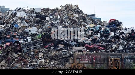 A pile of crushed vehicles and other metal sit in a huge pile at a metal scrapyard in Victoria, British Columbia, canada waiting for recycling. In the Stock Photo