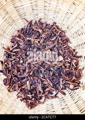 Dry raw mango slice closeup, dried fruit in bamboo bucket. Stock Photo