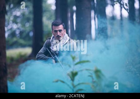 angry terrorist militant guerrilla soldier warrior in forest Stock Photo