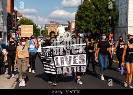 Washington, DC, USA. 8th Aug, 2020. Pictured: Protesters at the Black Lives Matter/Defund the Police March walk down M Street NW in Georgetown.  The banner calls for justice and has the names of hundreds of victims killed by police.. Credit: Allison C Bailey/Alamy Credit: Allison Bailey/Alamy Live News