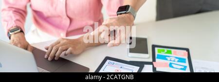 Graphic designers team work together with UX UI designer planning application template layout mobile phone prototype, User experience concept. Stock Photo