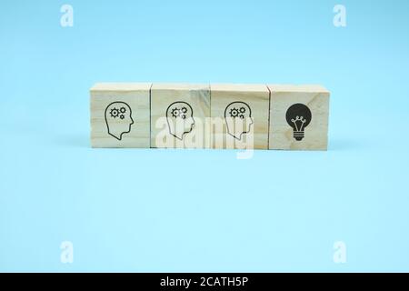 cubes with head symbols and hand that flips one revealing an idea Stock Photo