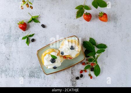 Scones with whipped cream and wildberry. Top view. Stock Photo