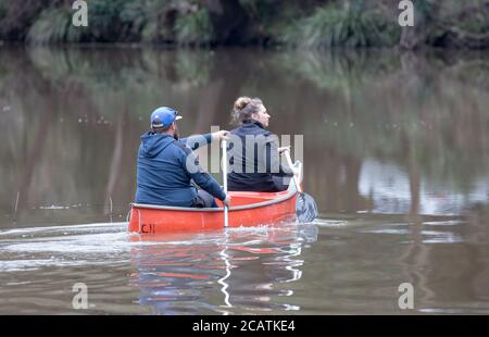 Couple paddling a conoe on the Hacking River, Royal National Park, Sydney Australia Stock Photo