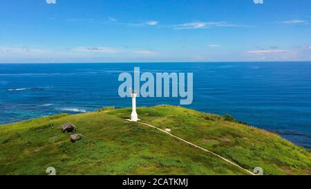 Lighthouse on a tropical island, top view. Beautiful landscape with a green island. Summer and travel vacation concept. Basot Island, Caramoan, Camarines Sur, Philippines. Stock Photo