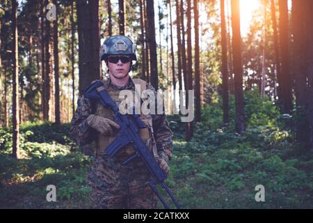 soldier portrait with  protective army tactical gear  and weapon in forest Stock Photo