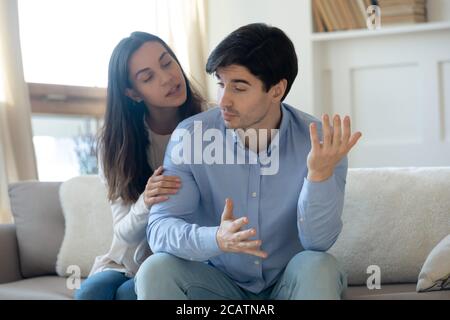Loving young guilty woman trying making peace with angry guy. Stock Photo