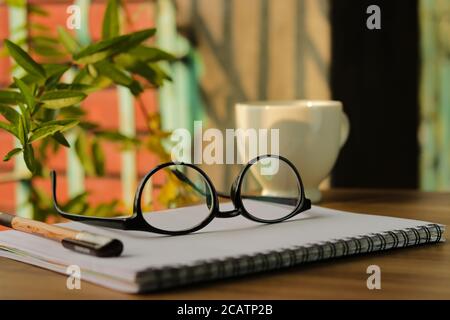 Eyeglasses on a notebook, with natural view. Stock Photo