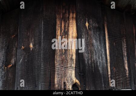 Dark wooden grunge background from planks. Old house wall Stock Photo