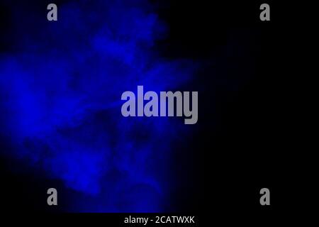 Abstract blue  powder explosion cloud  on dark background. Stock Photo