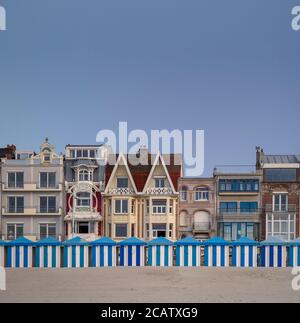 Blue and white striped beach huts against evening sky Stock Photo