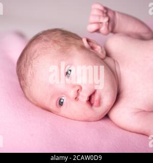 small newborn baby looks at the camera for nine days Stock Photo