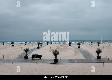 Empty beach of Ostend in Belgium against dark grey sky Stock Photo