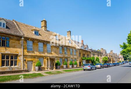 A roadside view of High Street with traditional Cotswold Stone cottages in Chipping Campden, a small market town in the Cotswolds in Gloucestershire Stock Photo