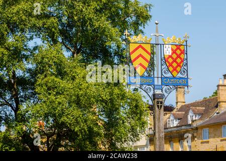 Heraldic roadside town name sign in High Street, central Chipping Campden, a small market town in the Cotswolds in Gloucestershire Stock Photo