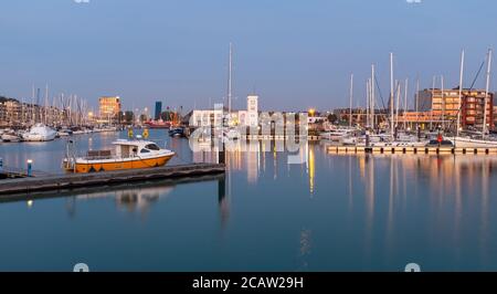 Sailing boats in the marina of Zeebrugge during blue hour. Long exposure image Stock Photo