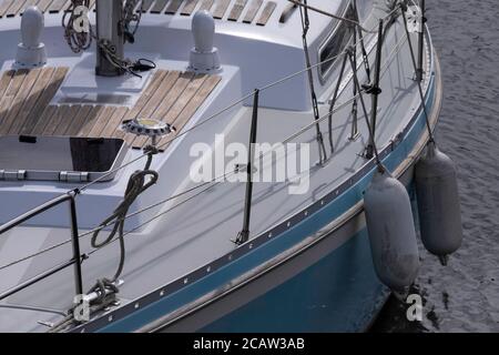 Fenders hanging next to a luxury sailing yacht to protect it when docking at the quay Stock Photo