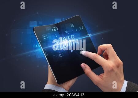 Businessman holding a foldable smartphone with SERVER SECURITY inscription, cyber security concept Stock Photo