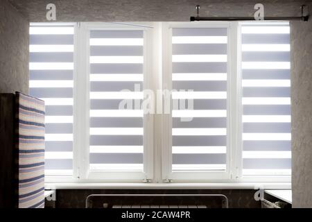 Windows with open modern horizontal blinds indoors, closeup. Stock Photo