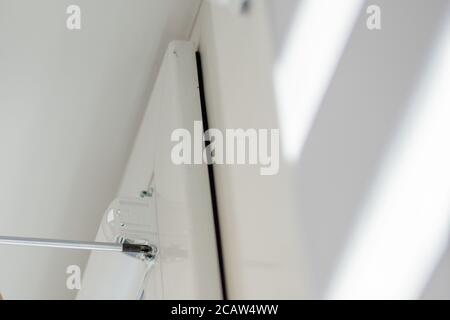 Man installing cassette roller blinds on windows Stock Photo