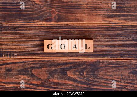 GOAL word made with building blocks on dark wooden background. Business goal concept Stock Photo