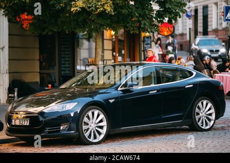 Tesla Model S Car In Motion On Street. The Tesla Model S Is A Full-sized All-electric Five-door, Luxury Liftback, Produced By Tesla Inc. Stock Photo