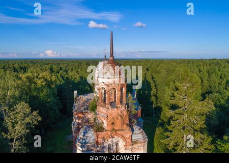 Bell tower of the abandoned old Trinity Church (Life-Giving Trinity in Yazvishchi) close-up on a sunny July evening. Novgorod region, Russia Stock Photo