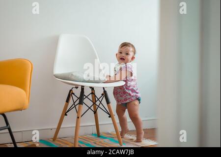 Baby girl playing in nursery room Stock Photo