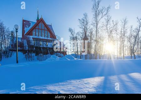 Kiruna church or Kiruna kyrka with the sun slowly setting behind trees Stock Photo