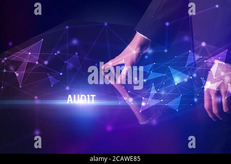 Businessman touching huge screen with AUDIT inscription, modern technology business concept Stock Photo
