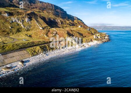 The eastern coast of Northern Ireland and Causeway Coastal Route a.k.a Antrim Coast Road A2. One of the most scenic coastal roads in Europe. Aerial vi Stock Photo