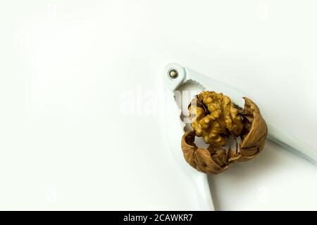 Group of crushed walnuts close-up on a white background. Stock Photo