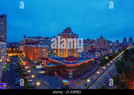 Night aerial view on Obolon area of Kyiv city with illumination. Flying drone camera shot. Stock Photo