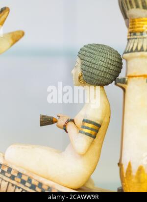 Egypt, Cairo, Tutankhamon alabaster, from his tomb in Luxor : Detail of a boat, woman sitting in front of a kiosk. She holds a lotus. Stock Photo